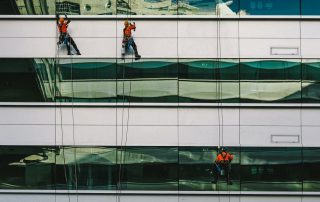 A professional cleaning commercial glass in CA