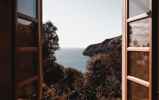 A picture of an open wooden framed glass window. We can help when a troubled window won't open or close